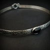 Hand crafted in the floral pattern Soft and Sweet, this artisan collar is hand crafted in sterling silver with a Black Onyx cabochon hand set into a sterling silver bezel. 