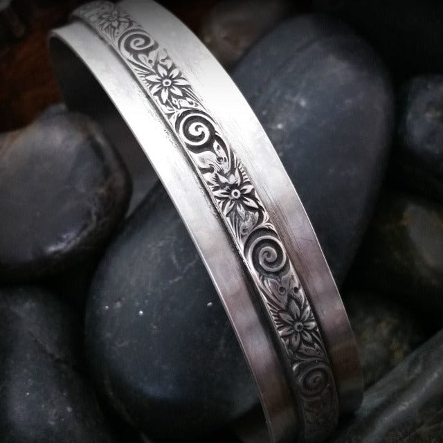 Wild Flower Wide Sterling Silver Cuff Bracelet. Luxurious solid sterling silver in a nice and heavy 19 gauge, the cuff measures approx. 3/4" wide with a floral center soldered onto the cuff. Oxidized to add depth and detail.