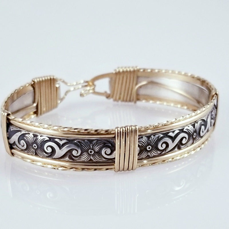 The ‘ZUZY’ collection, hand crafted in a flirty floral pattern of sterling silver and wire wrapped with gold accents.
